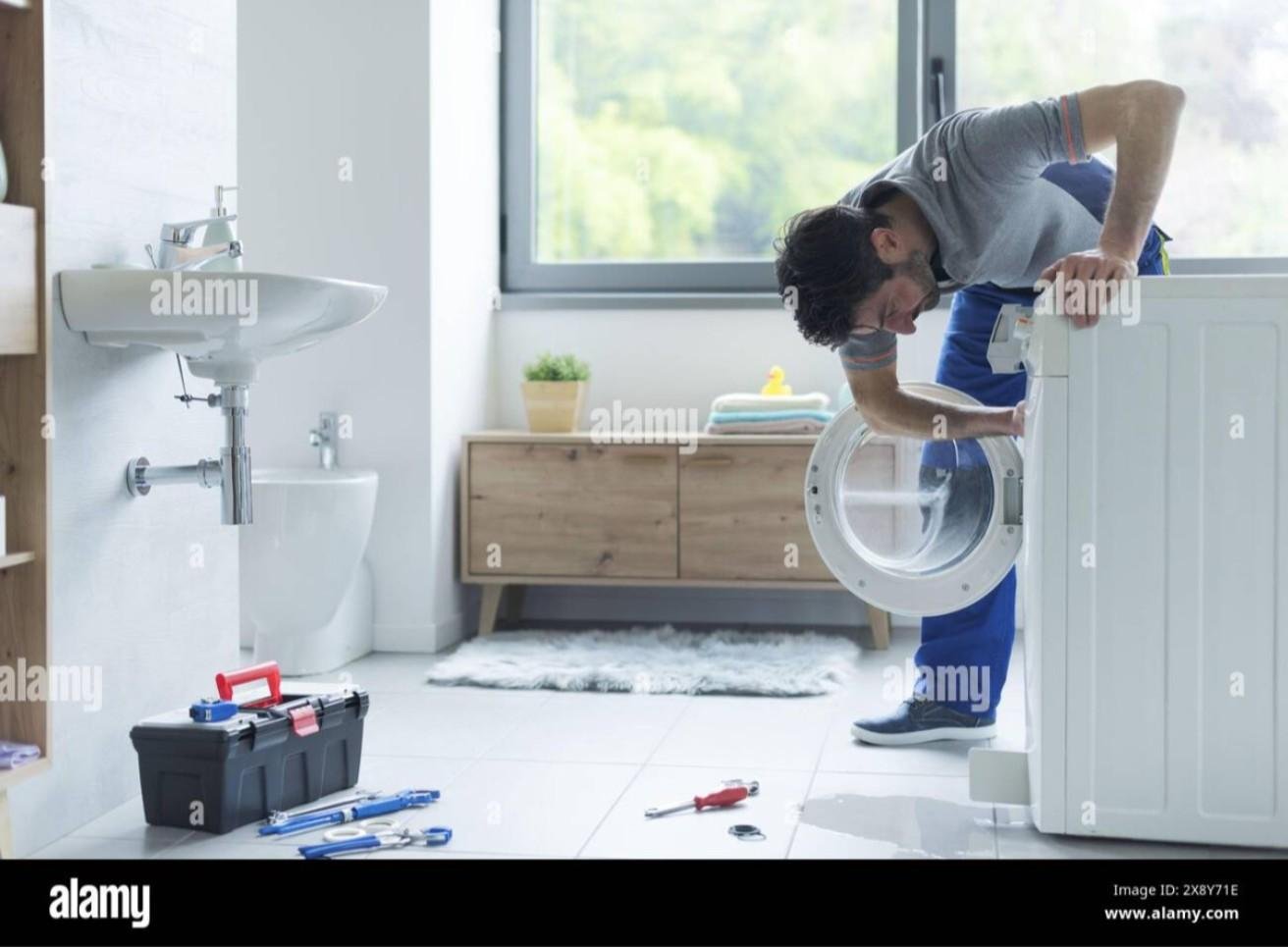 Professional technician repairing a washing machine in a modern home, demonstrating common washing machine problems and expert fixes.